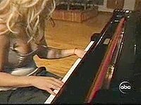 Sexy blonde celeb Britney Spears shows off her amazing rack in a tubetop in this video of her playing the piano.